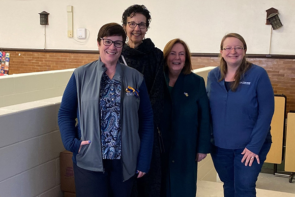 From left, Wendy Oleksy, principal of Columbus School, Laura Kann, governor of District 6420, Pat Merryweather-Arges, Rotary International Director, and Erika Dahlgren, a consultant with Usborne Books and More, help deliver books at Columbus Elementary School.